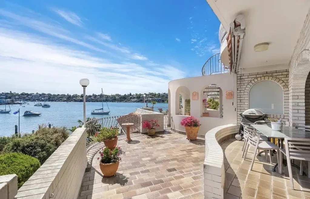 Sun-Drenched Waterfront Oasis with Panoramic Views & Double Garage