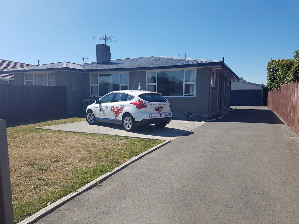 Three Double Bedrooms And Garaging In Great Location