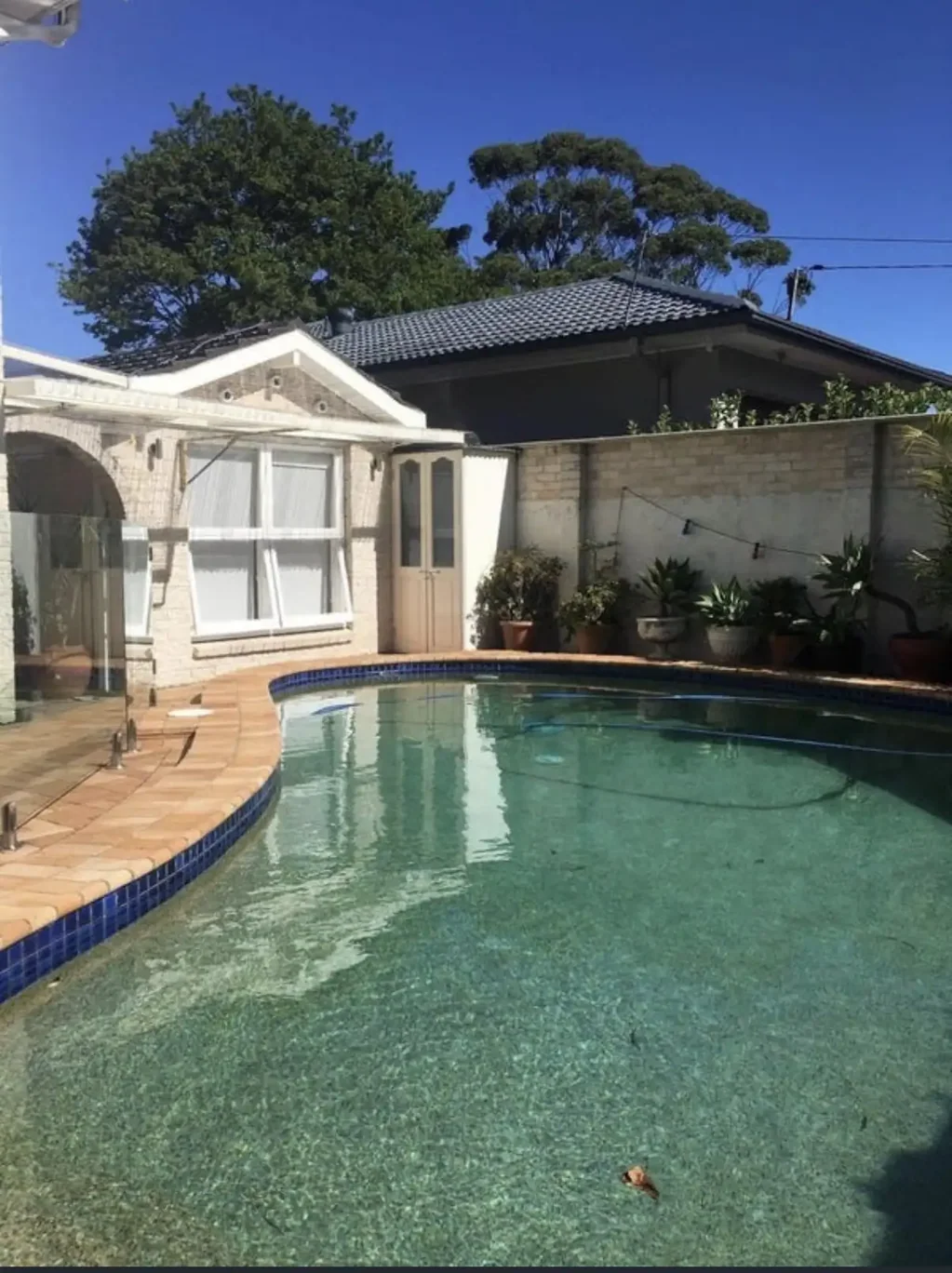 Private one-bedroom flat on a quiet corner block, with its own entrance and the pool right outside the window.