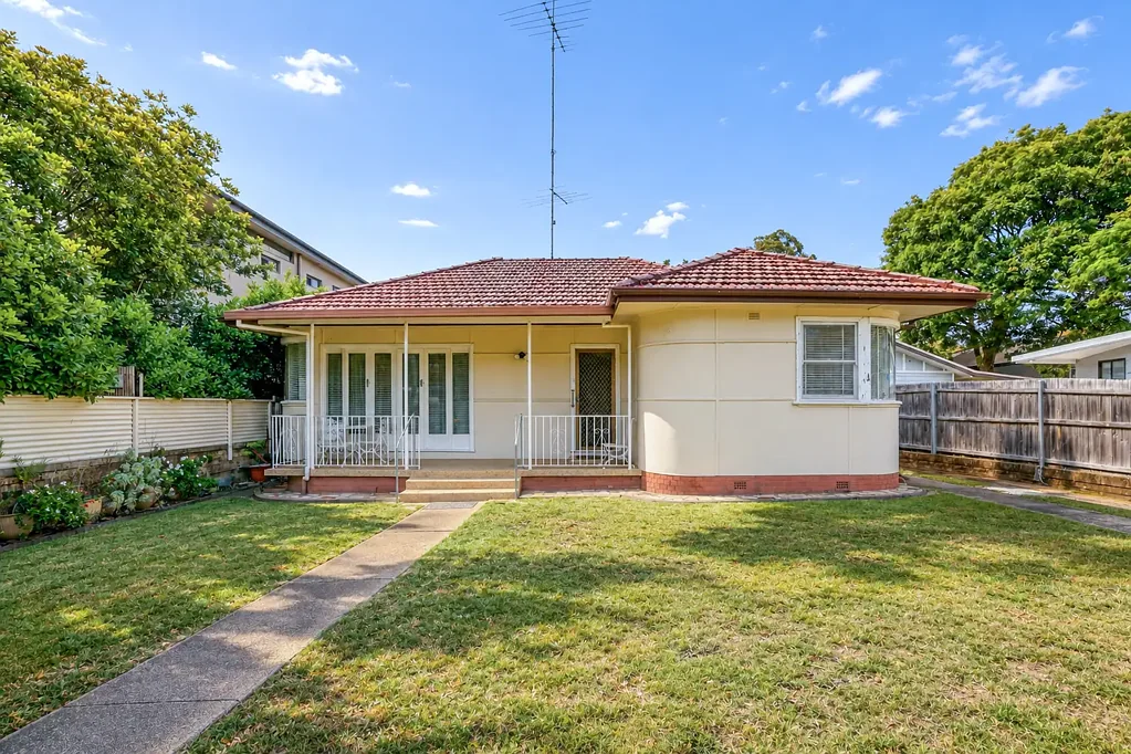 CONVENIENTLY LOCATED THREE BEDROOM HOME + SUNROOM
