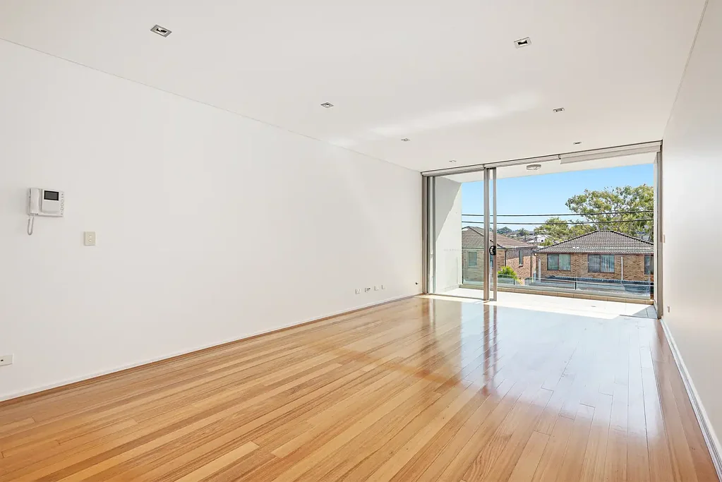 Unfurnished dual level apartment with courtyard, secure parking + storage