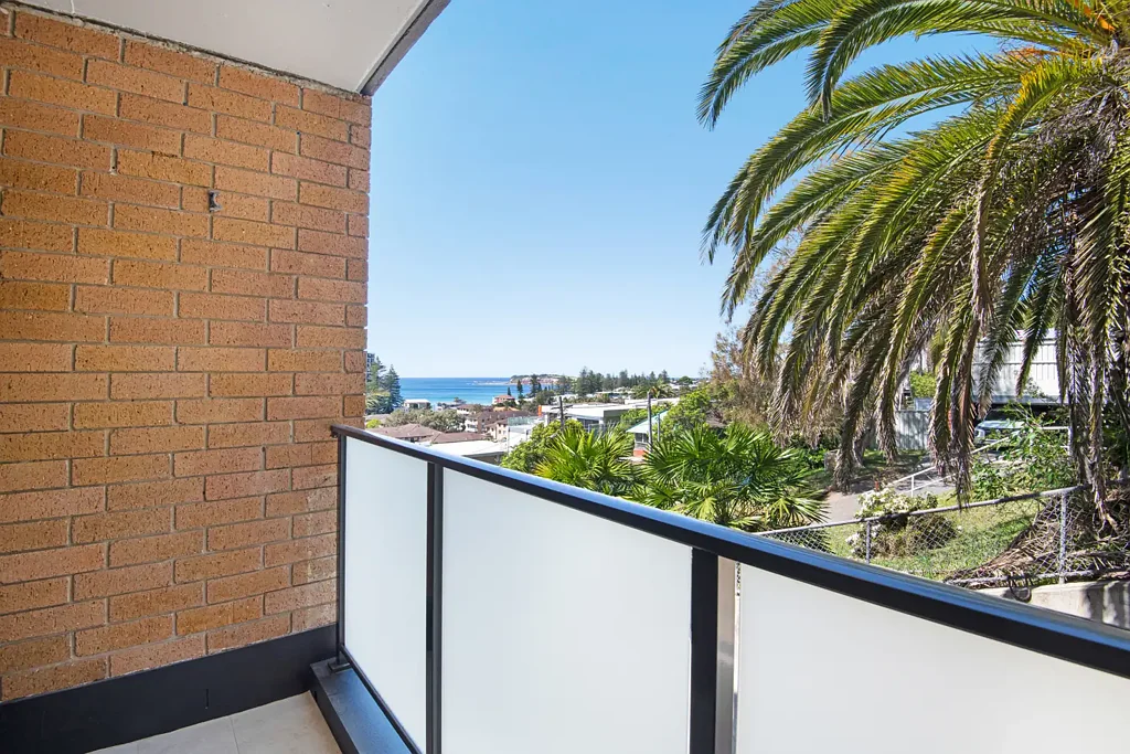 " Elevated Coastal Apartment with Glimpses of the Ocean "