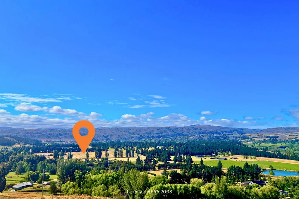 Alexandra Life framed by mountains & endless blue skies